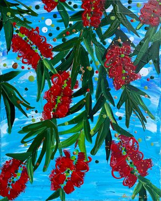 Close up of 9 bright red bottlebrush flowers hanging from a tree with a bright blue sky background. 