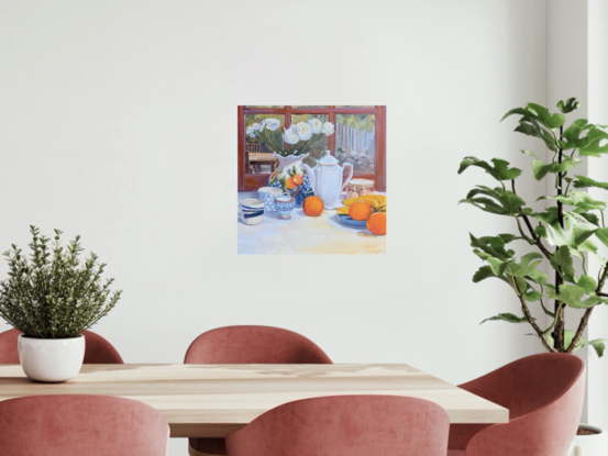 A vase with ranunculus, fruit, and crockery on a table, with a yard in the background.