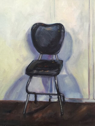 A painting of a chair in the studio.