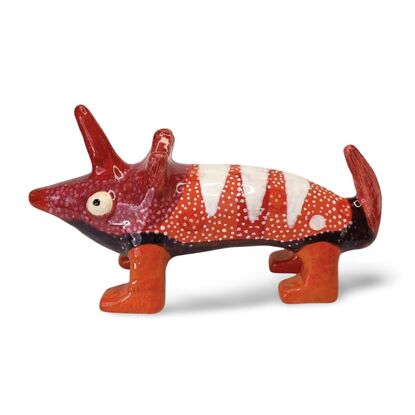 The Spotted Wombat features a playful, abstract rendition of a wombat, glazed in a striking deep blue with contrasting white circular spots and a red snout.