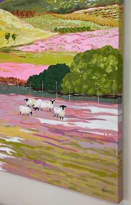 5 Black faced sheep grazing in a colourful landscape.