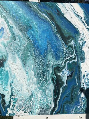 Various hues of blues/jade/white moving across the canvas  representing the dynamic movement of coastal waves through a series of flowing lines. The colours transition smoothly from deep blues to lighter blues and metallic jade creating a sense of depth and motion.