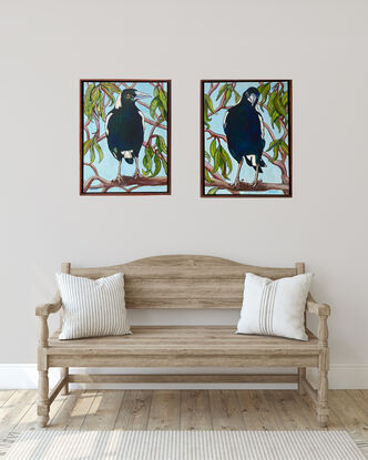 Two paintings that hang side by side. On each painting there is a close up of a magpie sitting on the branches of a gum tree.  Both magpies show all the blues and greens that can be seen amongst their black and white feathers when the sun is shining on them. 