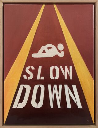 Relaxing pictogram with 'Slow down' painted on the street