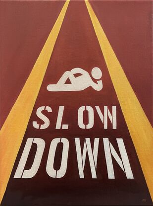 Relaxing pictogram with 'Slow down' painted on the street