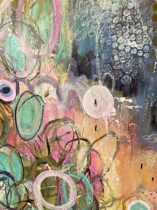 A soft, quiet, but energetic painting.  Soft hues are painted beneath, with drawings of circles and ovals in contrasting paint, crayon, pencil in various sizes.