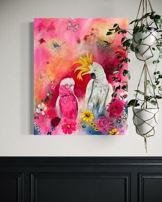 yellow crested cockatoo and pink galah surrounded by florals and abstract marking. Pink background