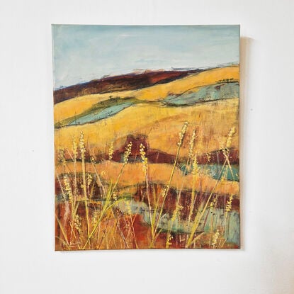 rich golden and red ochre landscape with pale yellow highlights and golden yellow grasses in the foreground