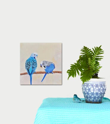 A textured oil painting of two blue budgerigars perched on a branch and gossiping about their friends! One has his back to the viewer and the other facing front and downwards.