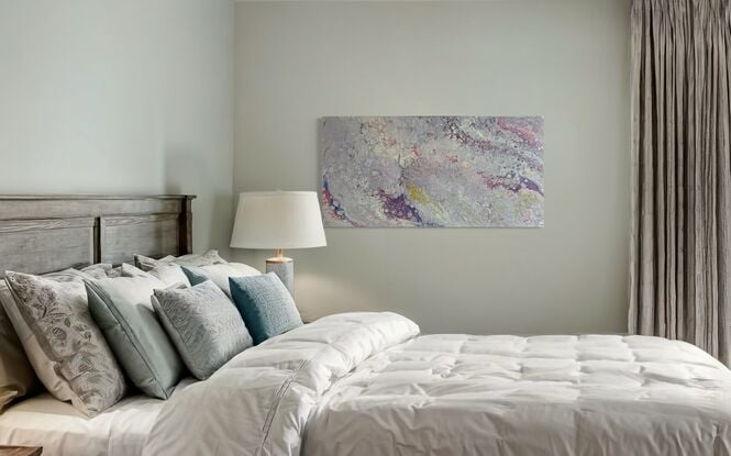 A fluid art painting titled “Lavender Mists” by Laura Anderson. The piece features soft, swirling shades of lavender, blush, pale gold, and subtle hints of blue. The abstract patterns resemble flowing mists, creating an ethereal and tranquil atmosphere with organic textures and fluid movements across the canvas.