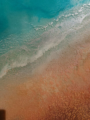 Textured aerial view inspired by a crystal clear beach and surfer.