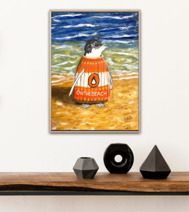 A solitary penguin, wearing a knitted orange and white jumper resembling a Penguin Classic book, features the title "On The Beach" inspired by Neville Shute's novel. This lone penguin stands at the shoreline, perfectly embodying the playful wordplay of being "on the beach."