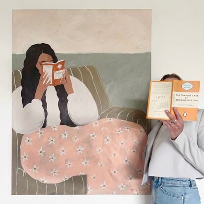 Beige background, woman reading book