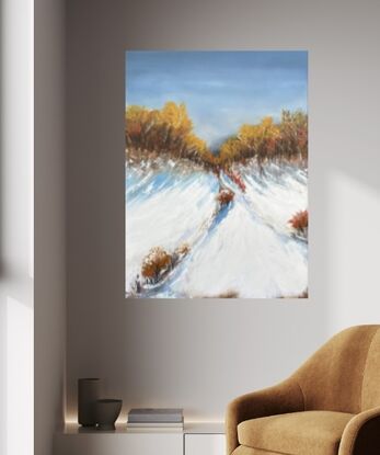 Under a dark blue moody sky sits a mountain top covered in snow with large trees up the top with leaves  in ochre and red gold hues.