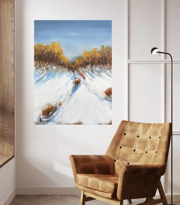 Under a dark blue moody sky sits a mountain top covered in snow with large trees up the top with leaves  in ochre and red gold hues.