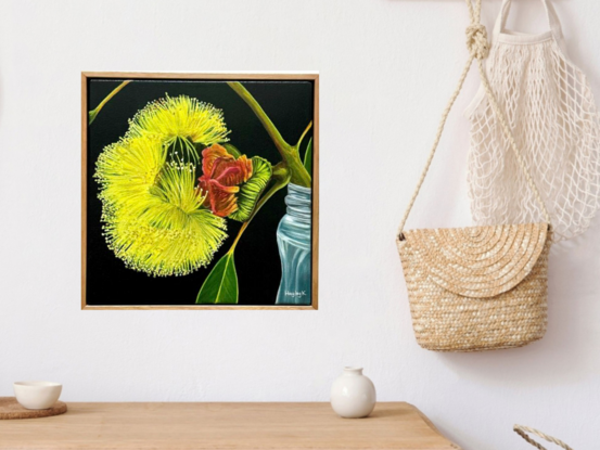 The painting features a bright yellow flower in full bloom with a red gum nut  set against a dark background. The flower rests in a simple glass jar, creating a striking contrast with the moody backdrop.