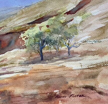 Red gorge, golden country, sparse gum trees, clear sky, distant ranges. Vast landscape