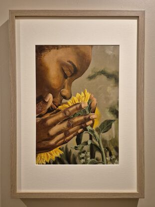 African woman smelling a sunflower