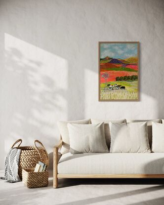 A group of cows grazing under a windmill in a bright landscape.