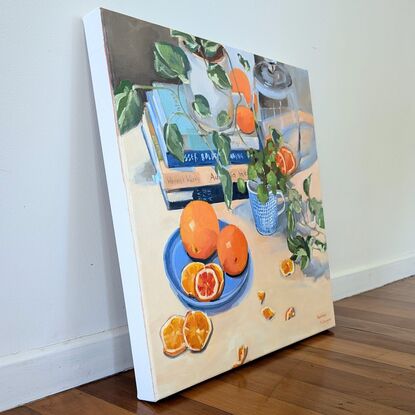 Composition with cooking books, plants, tableware and oranges