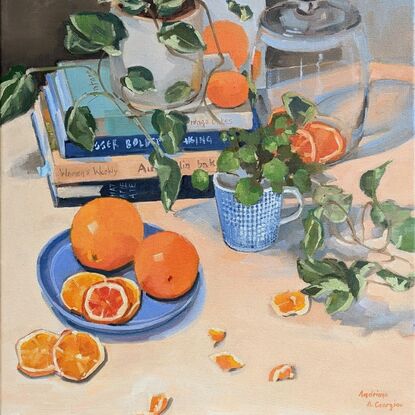 Composition with cooking books, plants, tableware and oranges