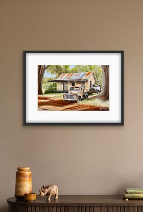 Australian Outback and two rusty old Ute’s  and house underneath the gumtrees.