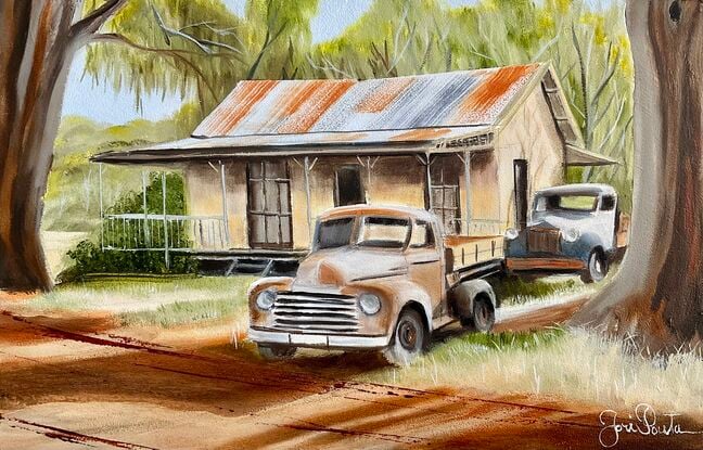 Australian Outback and two rusty old Ute’s  and house underneath the gumtrees.