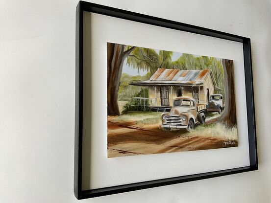 Australian Outback and two rusty old Ute’s  and house underneath the gumtrees.