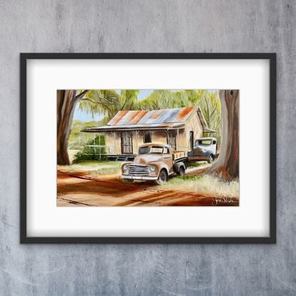 Australian Outback and two rusty old Ute’s  and house underneath the gumtrees.