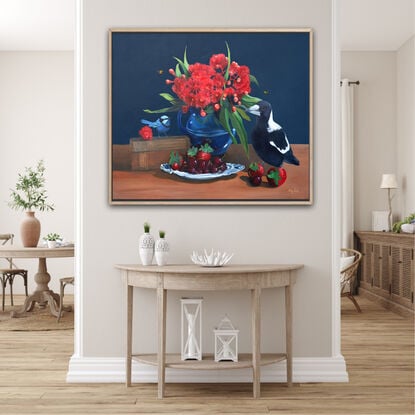 Magpie and fairywren on a tabletop with gum blossom and cookbooks and fruit. 