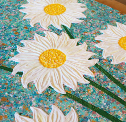 white and yellow textured flowers in a pink vase on a sky blue background