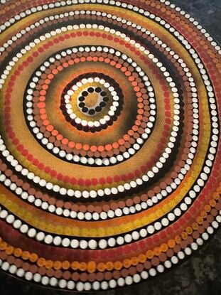 Circular Indigenous dot painting, warm tones