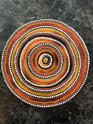 Circular Indigenous dot painting, warm tones