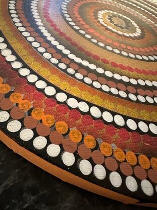 Circular Indigenous dot painting, warm tones