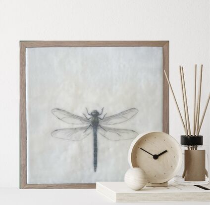 Welcome to the enchanting world of our mixed media and encaustic wax artwork featuring a stunning dragonfly in soothing blue tones. This piece captures the essence of nature's grace with delicate wings that seem almost ethereal. Every detail is meticulously incised, creating a sense of depth and texture that draws you in. Measuring at a cozy 28cm x 28cm, this artwork is elegantly presented in a timber floating frame, adding a touch of modern sophistication to its natural charm. The combination of mixed media and encaustic wax brings a unique tactile quality to this piece, inviting you to explore the intricate beauty of the dragonfly up close. With its serene color palette and intricate details, this artwork is sure to mesmerize and captivate anyone who beholds it. A true ode to the delicate yet resilient nature of the dragonfly, this piece is a perfect addition to any art lover's collection.