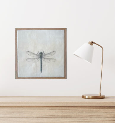 Welcome to the enchanting world of our mixed media and encaustic wax artwork featuring a stunning dragonfly in soothing blue tones. This piece captures the essence of nature's grace with delicate wings that seem almost ethereal. Every detail is meticulously incised, creating a sense of depth and texture that draws you in. Measuring at a cozy 28cm x 28cm, this artwork is elegantly presented in a timber floating frame, adding a touch of modern sophistication to its natural charm. The combination of mixed media and encaustic wax brings a unique tactile quality to this piece, inviting you to explore the intricate beauty of the dragonfly up close. With its serene color palette and intricate details, this artwork is sure to mesmerize and captivate anyone who beholds it. A true ode to the delicate yet resilient nature of the dragonfly, this piece is a perfect addition to any art lover's collection.