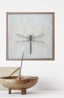 Welcome to the enchanting world of our mixed media and encaustic wax artwork featuring a stunning dragonfly in soothing blue tones. This piece captures the essence of nature's grace with delicate wings that seem almost ethereal. Every detail is meticulously incised, creating a sense of depth and texture that draws you in. Measuring at a cozy 28cm x 28cm, this artwork is elegantly presented in a timber floating frame, adding a touch of modern sophistication to its natural charm. The combination of mixed media and encaustic wax brings a unique tactile quality to this piece, inviting you to explore the intricate beauty of the dragonfly up close. With its serene color palette and intricate details, this artwork is sure to mesmerize and captivate anyone who beholds it. A true ode to the delicate yet resilient nature of the dragonfly, this piece is a perfect addition to any art lover's collection.