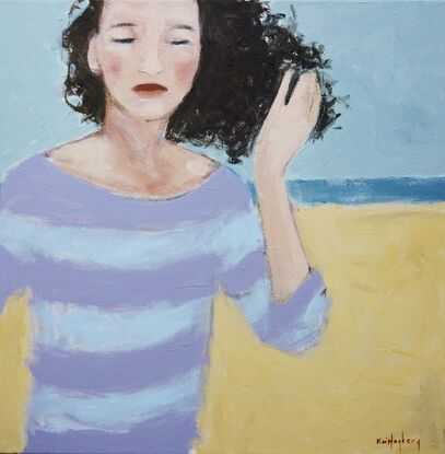 Woman on the beach, her hair blown by wind