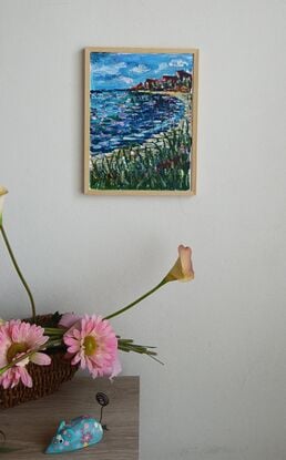 An impression of a beach .         Painting has a simple pine frame.     