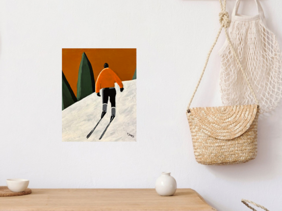 A lone male skier is view from behind. He is wearing an orange jackets and black pants and ski boots. He is trekking up the white snow hill towards some green conifers in the distance. The sky above is a warm orangey brown colour. 