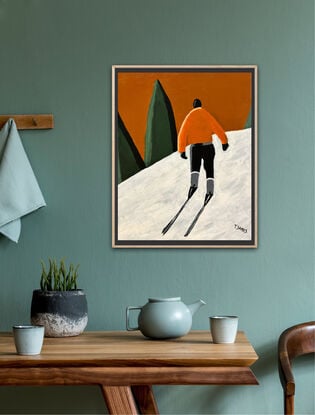 A lone male skier is view from behind. He is wearing an orange jackets and black pants and ski boots. He is trekking up the white snow hill towards some green conifers in the distance. The sky above is a warm orangey brown colour. 