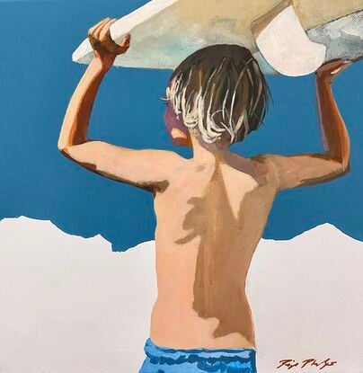 Boy with surfboard in front of a white cliff over blue water