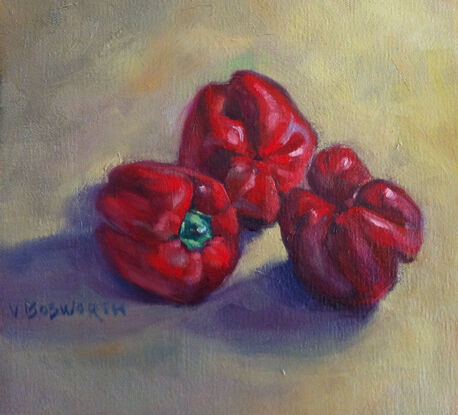 Three red capsicums on a yellow ochre background.