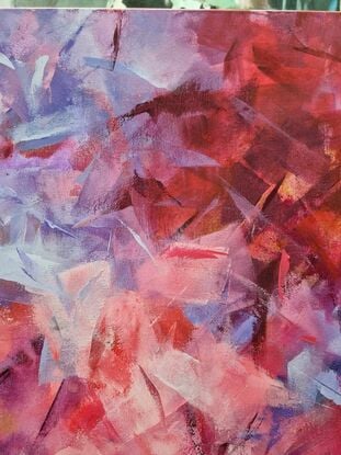 This listing is for a diptych. It's in various shades of pink, purple, and red.  It's an abstract, with patches of bright colours floating around the canvas