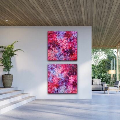 This listing is for a diptych. It's in various shades of pink, purple, and red.  It's an abstract, with patches of bright colours floating around the canvas