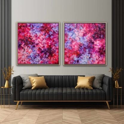 This listing is for a diptych. It's in various shades of pink, purple, and red.  It's an abstract, with patches of bright colours floating around the canvas