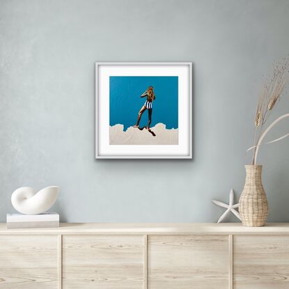 Tanned girl in blue and white striped bathers on white cliff with turquoise background 