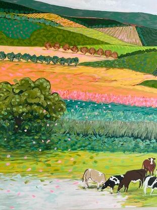 Cows grazing in a brightly coloured landscape.