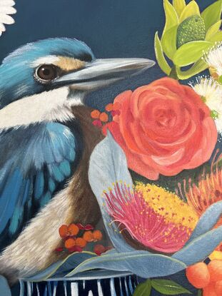 Sacred Kingfisher perched on a chinoserie vase filled with flowers. 