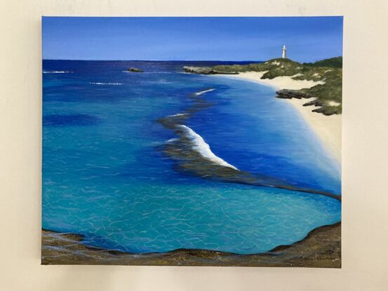 This artwork predominately reflects the blue and turquoise waters of Rottnest Island with Bathurst Lighthouse, rocks, sand and greenery in the background. The primary colours are turquoise, blue, yellow and brown and the ripples in the sand and water are light yellow and pale blue. 